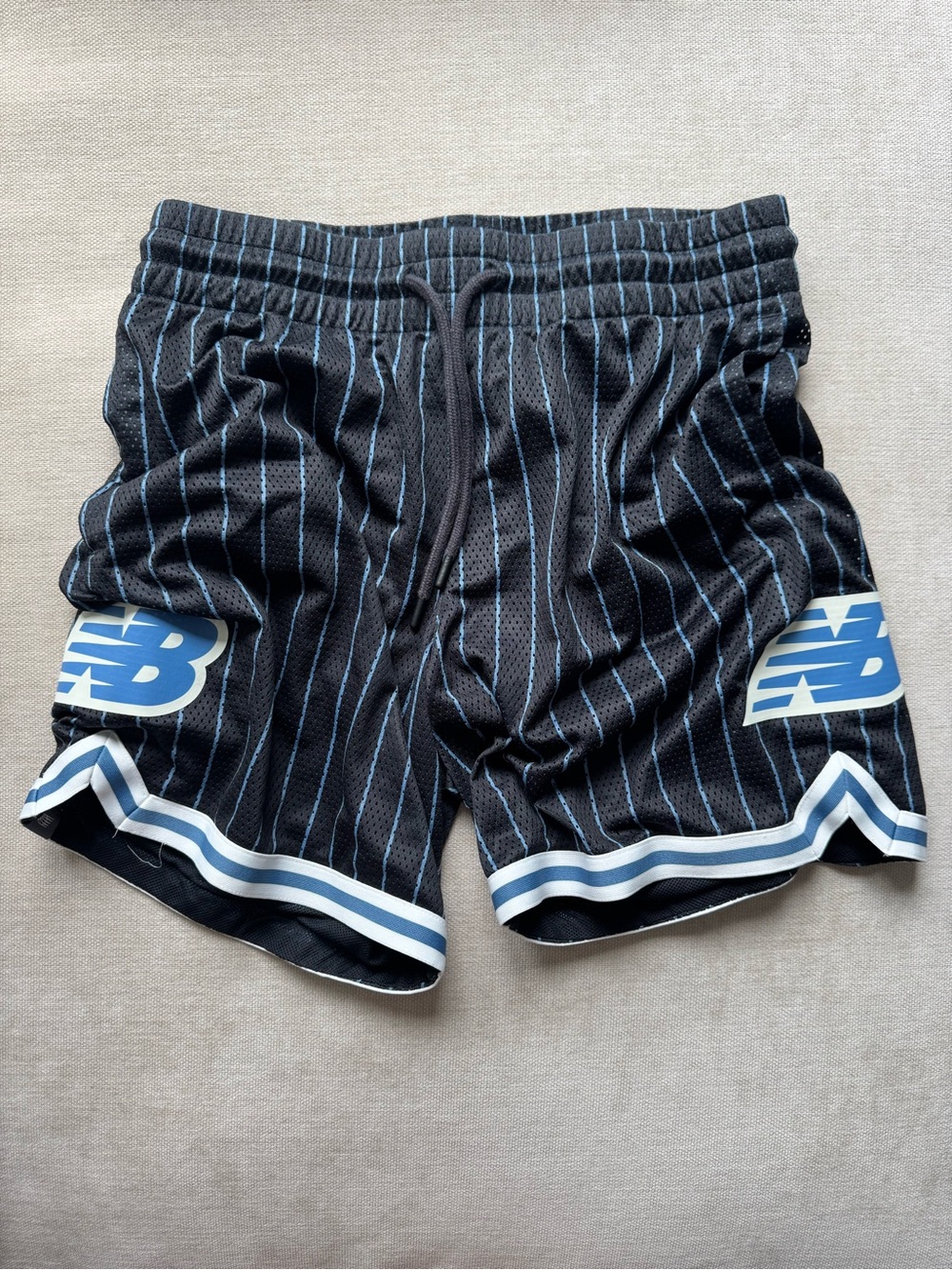 New Balance Black Athletic Shorts with Light Blue Pinstripes